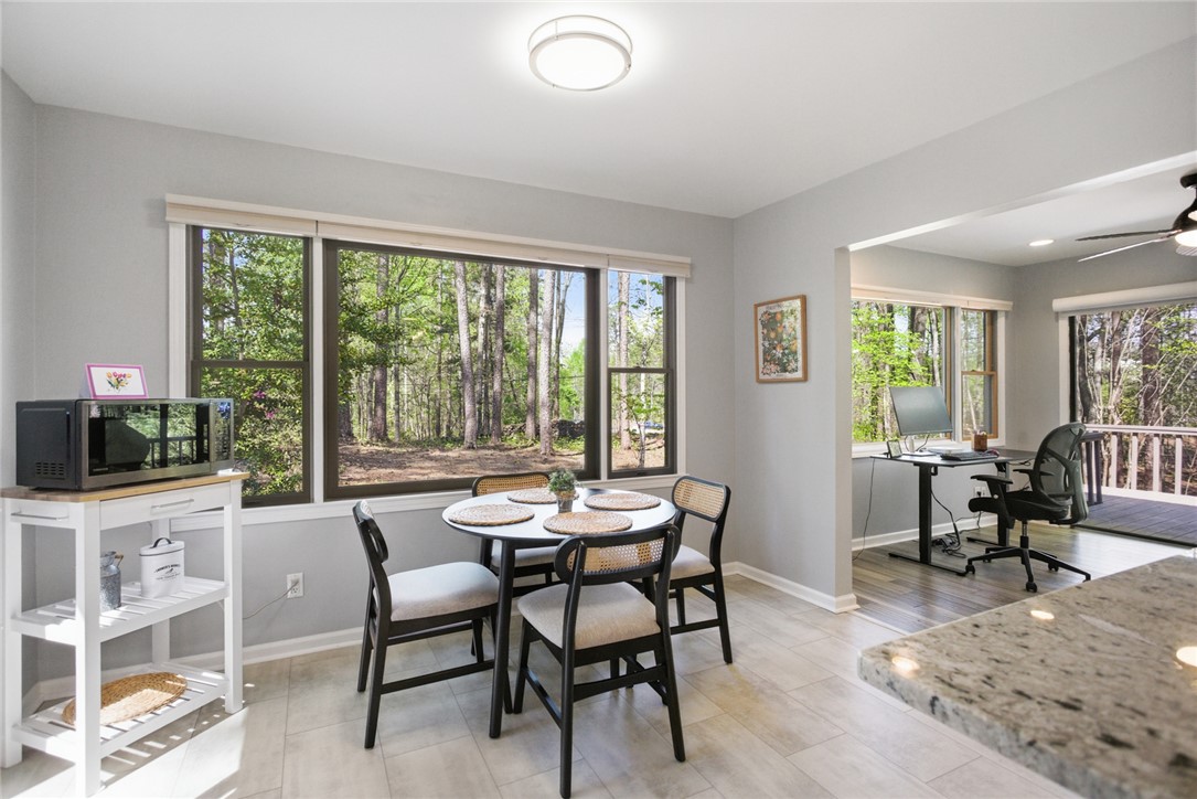 9 Tradewinds Way Salem, SC 29676 - Photo 13 of 45 Bright dining area with large windows offers serene views of the surrounding natural landscape.