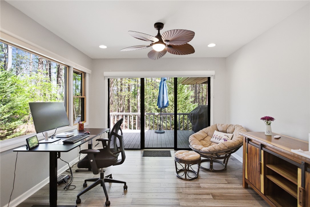 9 Tradewinds Way Salem, SC 29676 - Photo 15 of 45 An inviting room provides serene forest views through expansive windows and sliding doors.
