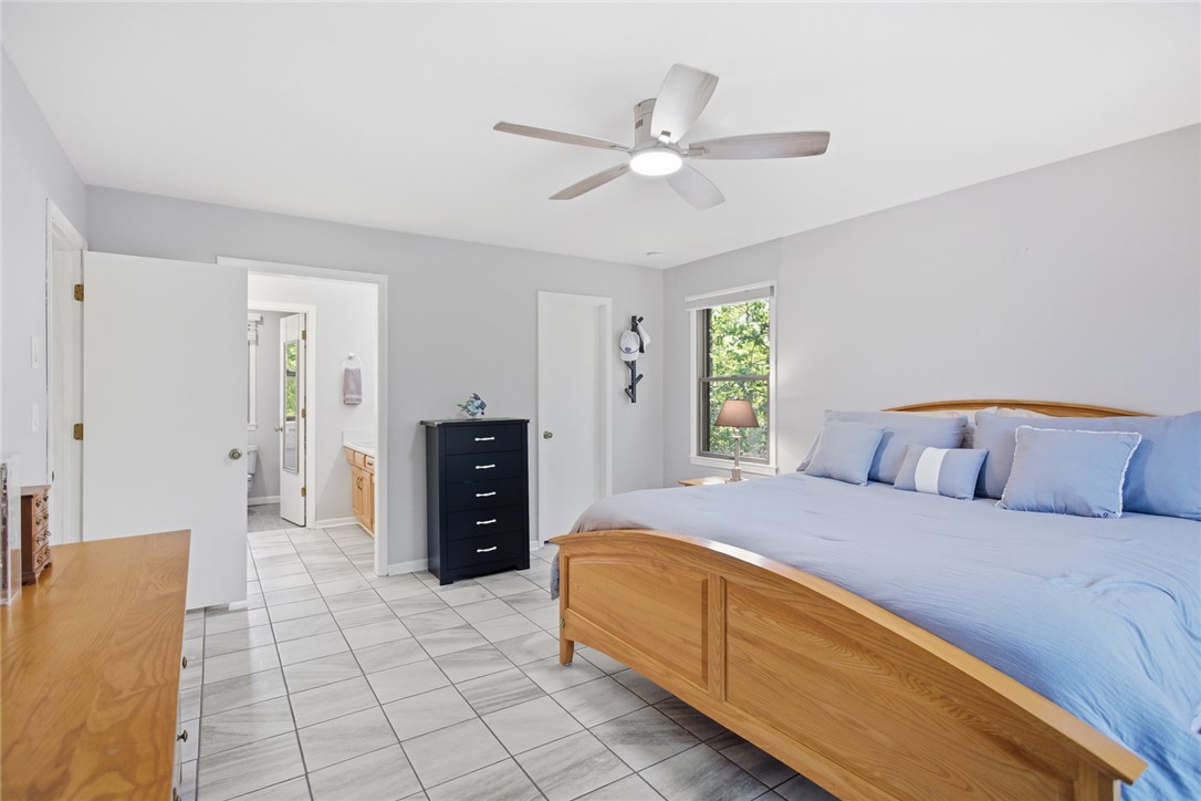 9 Tradewinds Way Salem, SC 29676 - Photo 20 of 45 Bright and airy bedroom with light tile flooring and direct access to a private bathroom.