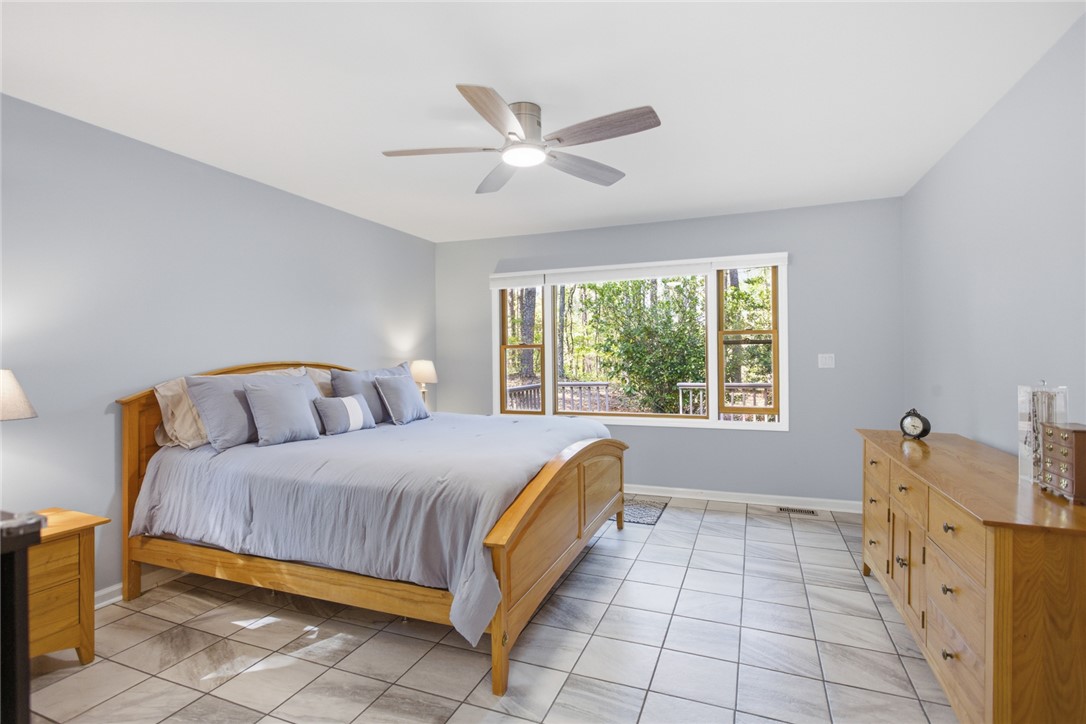 9 Tradewinds Way Salem, SC 29676 - Photo 21 of 45 Relax in this inviting bedroom, featuring a large window with peaceful outdoor views.