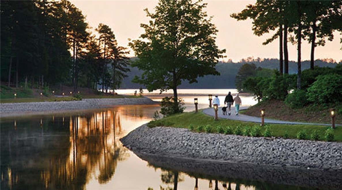 9 Tradewinds Way Salem, SC 29676 - Photo 45 of 45 A tranquil waterside path winds through lush greenery, inviting peaceful strolls at dusk.
