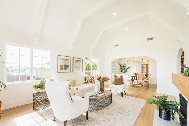 a kitchen with stainless steel appliances granite countertop a stove a sink and white cabinets
