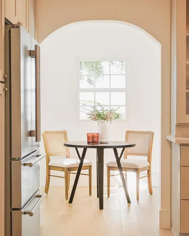 a view of a dining room with furniture and a chandelier