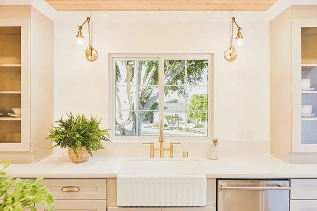 a stove top oven sitting inside of a kitchen