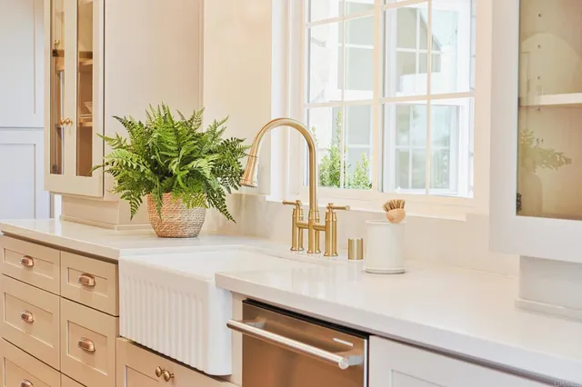 a kitchen with stainless steel appliances a stove a sink and a refrigerator