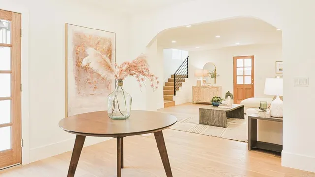 a living room with furniture and a potted plant