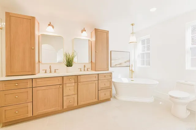 a bathroom with a sink a toilet and mirror