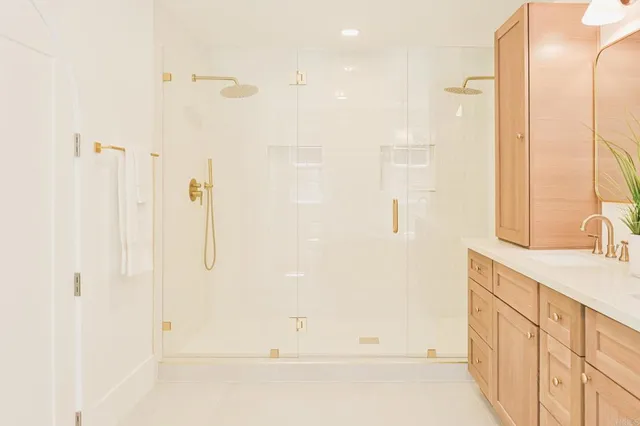 a bathroom with a sink mirror and a toilet