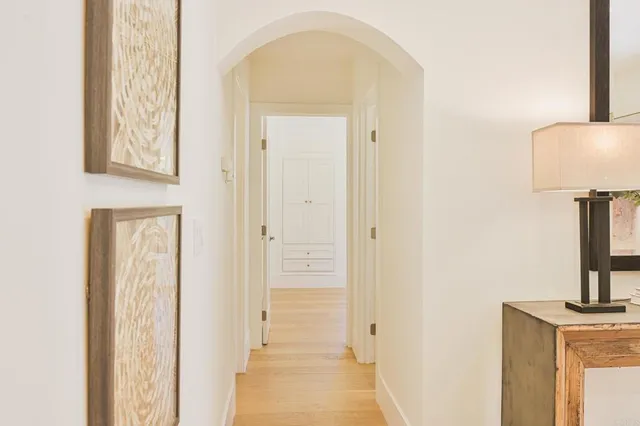a view of entryway and hall with wooden floor