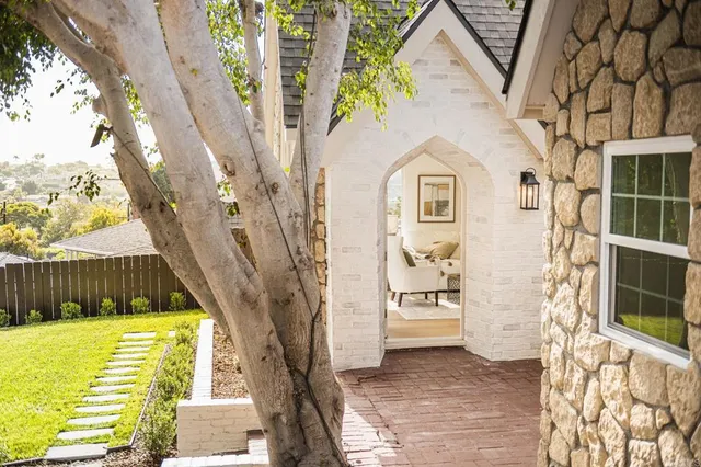 a kitchen with cabinets stainless steel appliances a sink and a window
