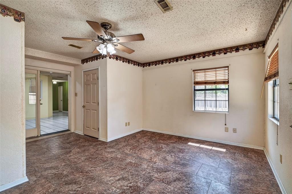 1403 Melba Doyle Park Road Decatur, TX 76234 - Photo 20 of 40 Wood-look flooring, ceiling fan with light fixture, sliding glass doors, and multiple windows