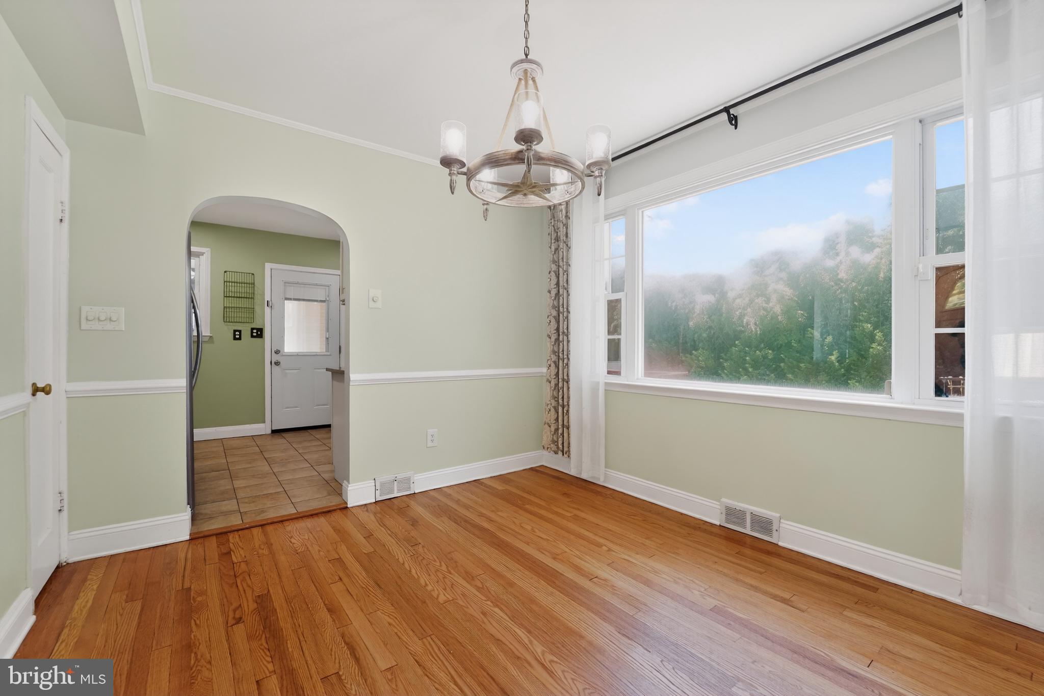 9408 Dana Vista Road Baltimore, MD 21236 - Photo 18 of 38 wooden floor in an empty room with a window
