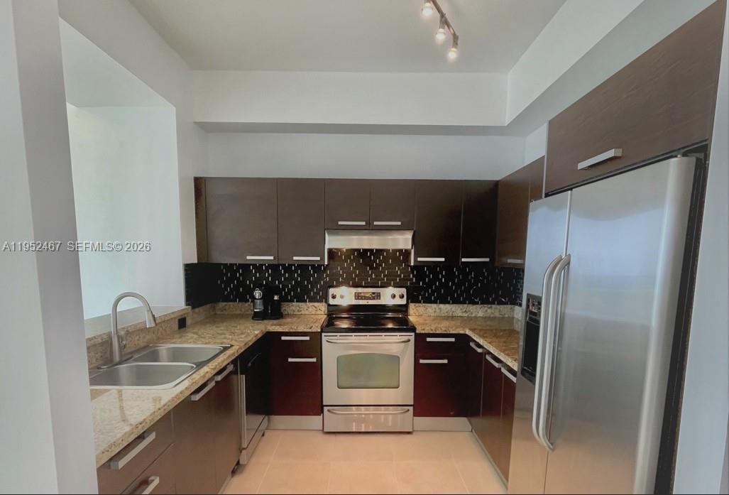2525 Southwest 3rd Avenue, Unit 1709 Miami, FL 33129 - Photo 3 of 15 a kitchen with a sink and a refrigerator