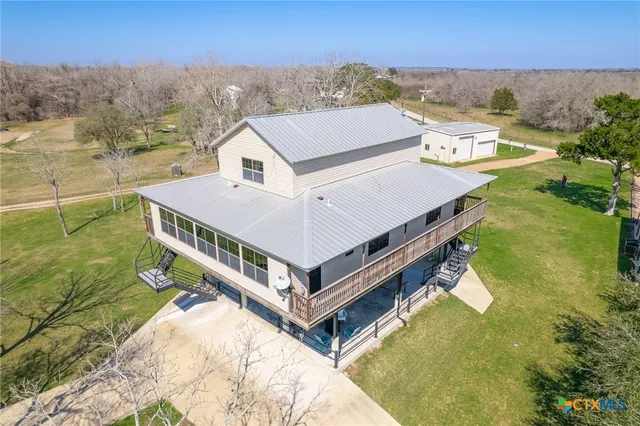 an aerial view of a house with a ocean view