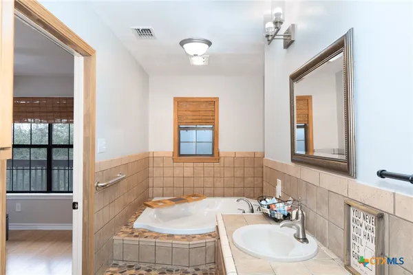 a bathroom with a sink and a mirror