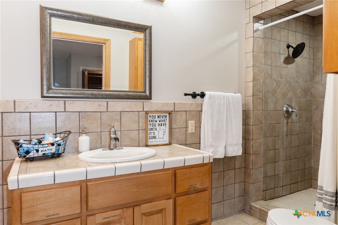 564 Cypress Valley Road Cuero, TX 77954 - Photo 21 of 33 a bathroom with a sink and a mirror