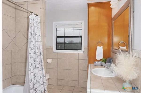 a bedroom with a bed and a mirror