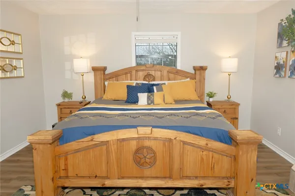 a bedroom with a bed and a chandelier