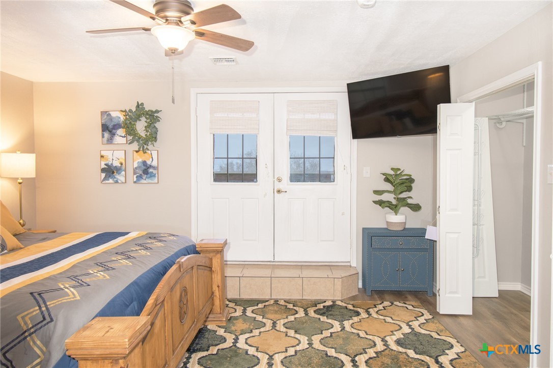 564 Cypress Valley Road Cuero, TX 77954 - Photo 29 of 33 a bedroom with a bed and a chandelier