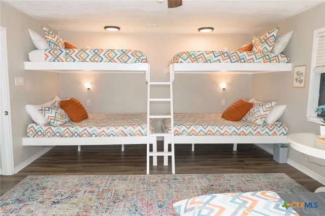 a bedroom with a bed a mirror and lamp