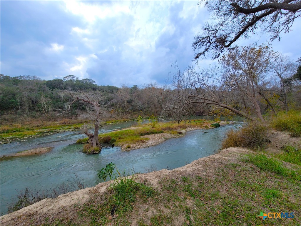 564 Cypress Valley Road Cuero, TX 77954 - Photo 3 of 33 a view of a lake with mountains in the background