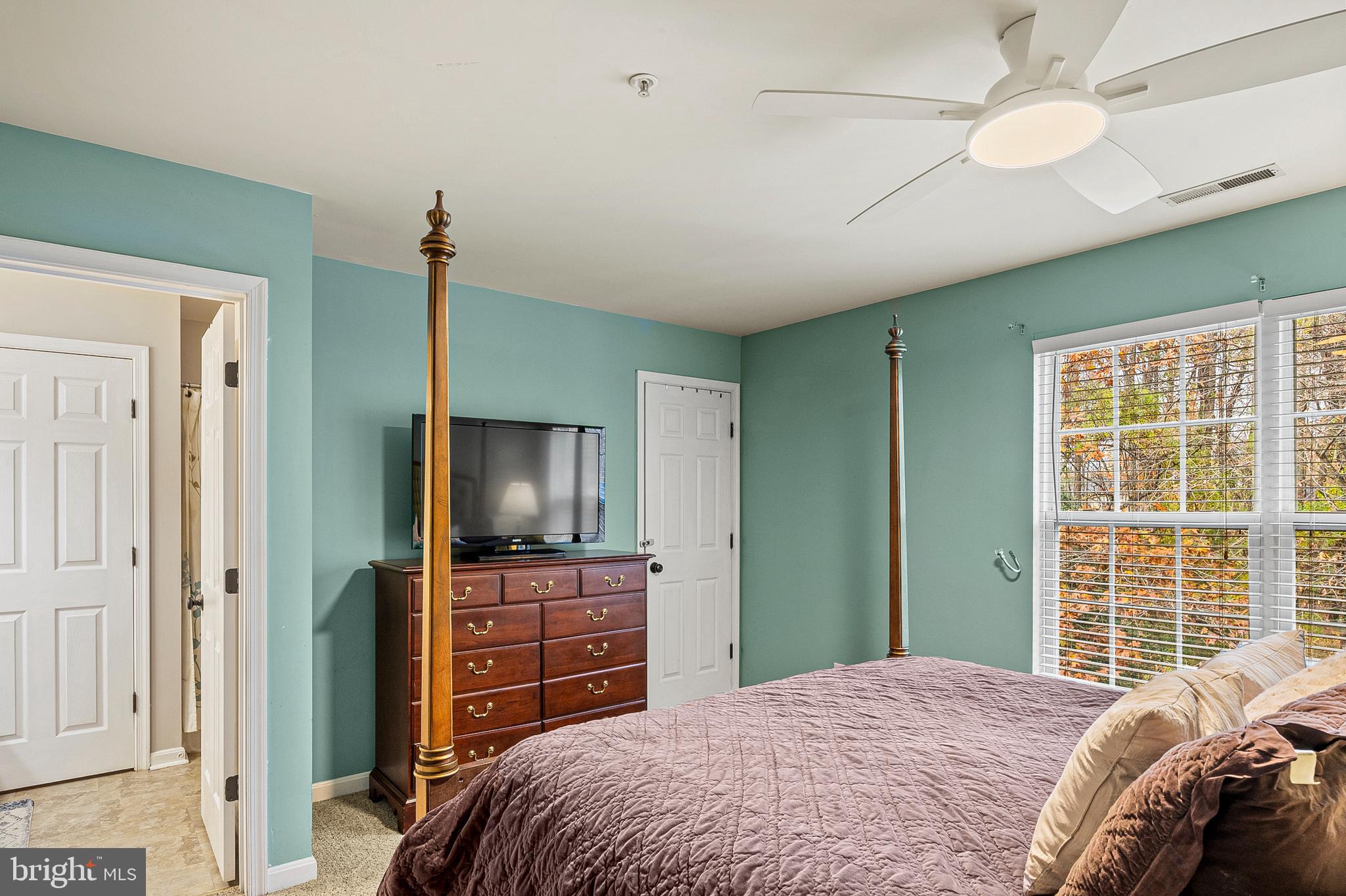 222 Gray Fox Court Edgewater, MD 21037 - Photo 16 of 42 a bedroom with a bed and a flat tv screen on dresser