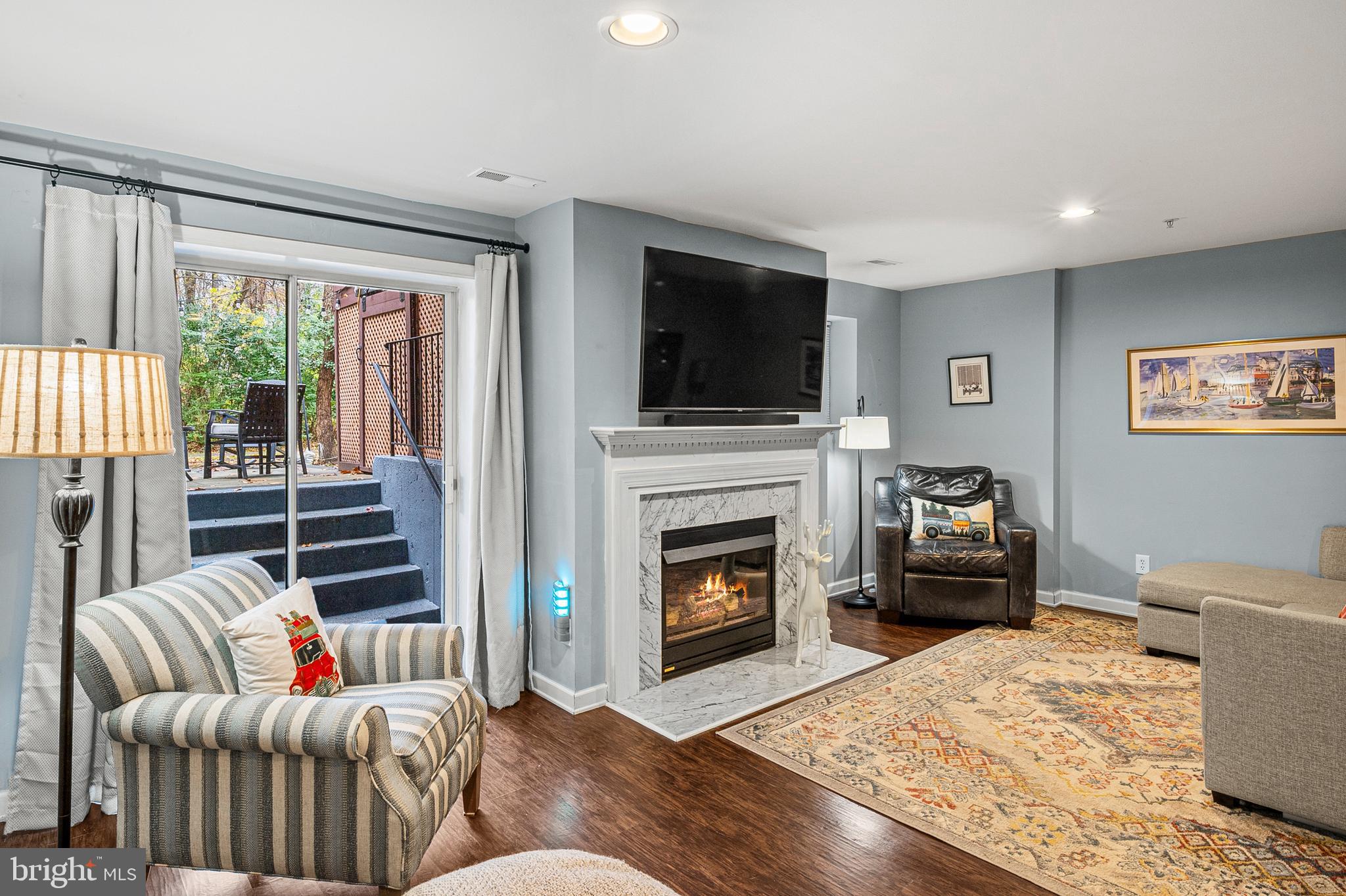 222 Gray Fox Court Edgewater, MD 21037 - Photo 24 of 42 a living room with furniture a flat screen tv and a fireplace
