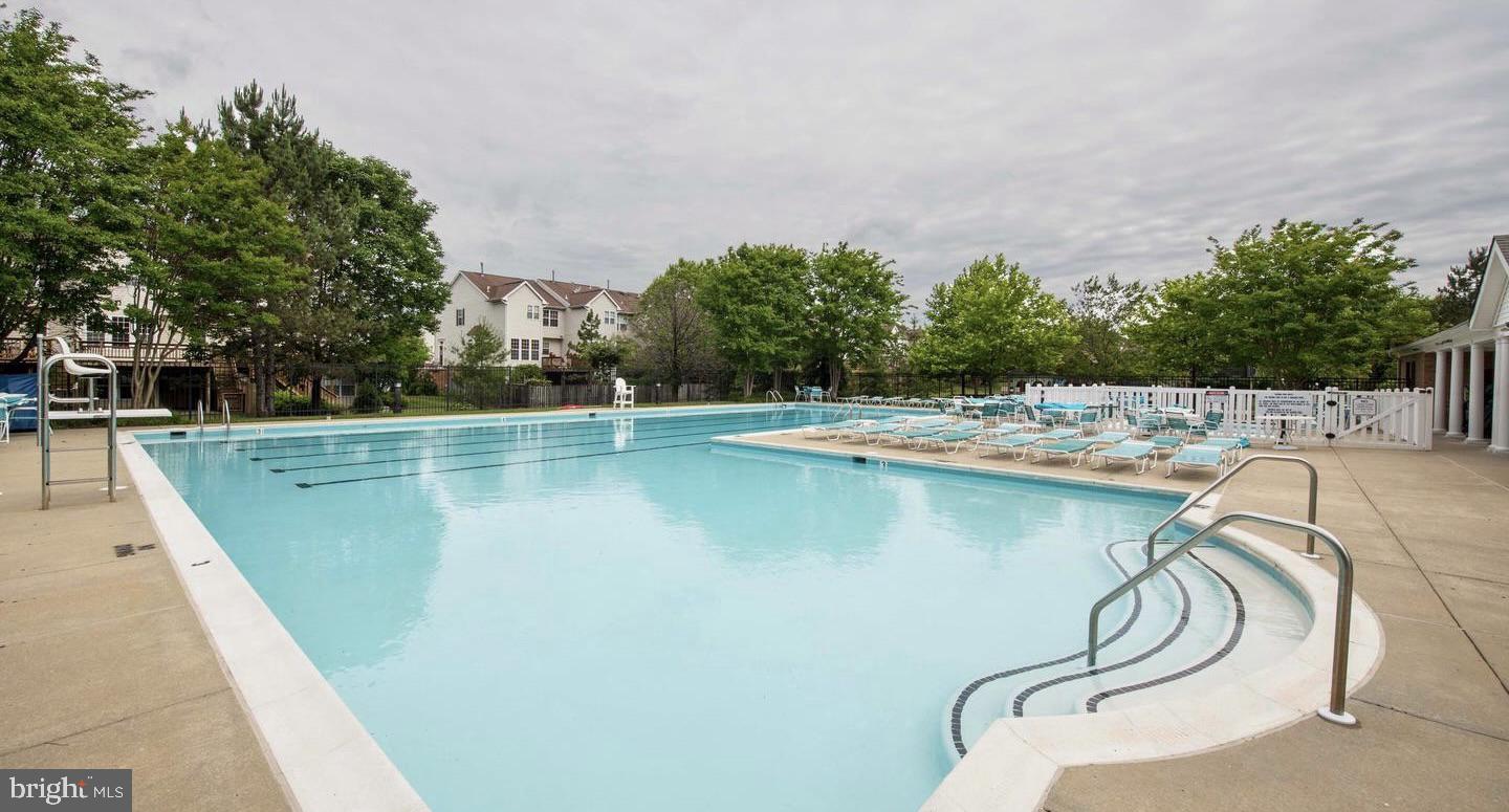 222 Gray Fox Court Edgewater, MD 21037 - Photo 36 of 42 a view of a swimming pool with a yard and seating area