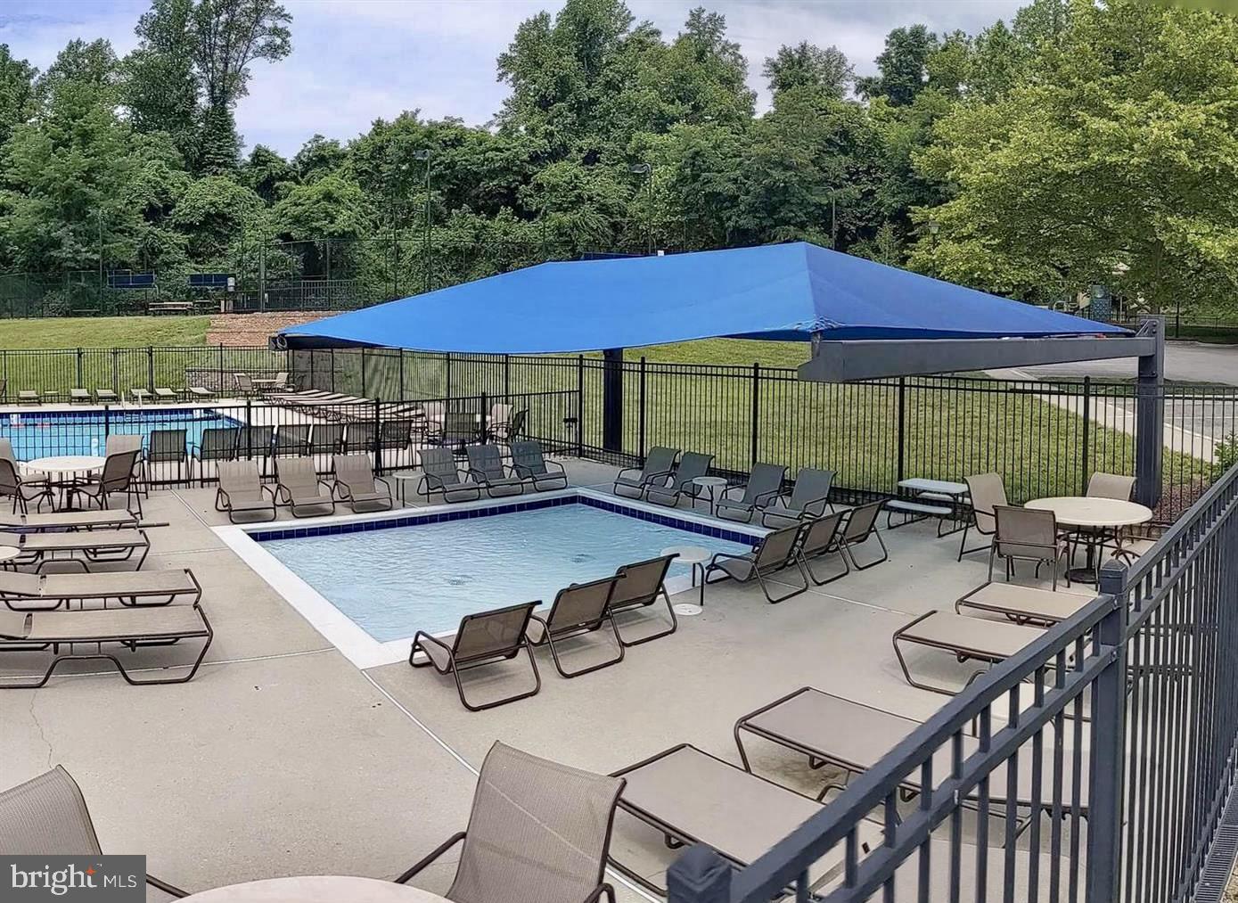 222 Gray Fox Court Edgewater, MD 21037 - Photo 38 of 42 a view of a patio with table and chairs under an umbrella