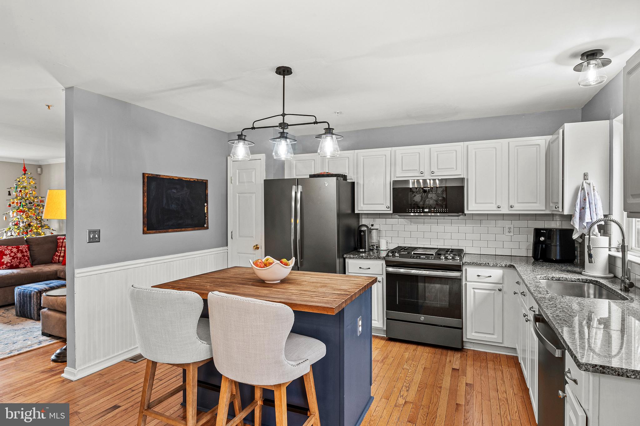 222 Gray Fox Court Edgewater, MD 21037 - Photo 4 of 42 a kitchen with stainless steel appliances a dining table chairs stove refrigerator and microwave