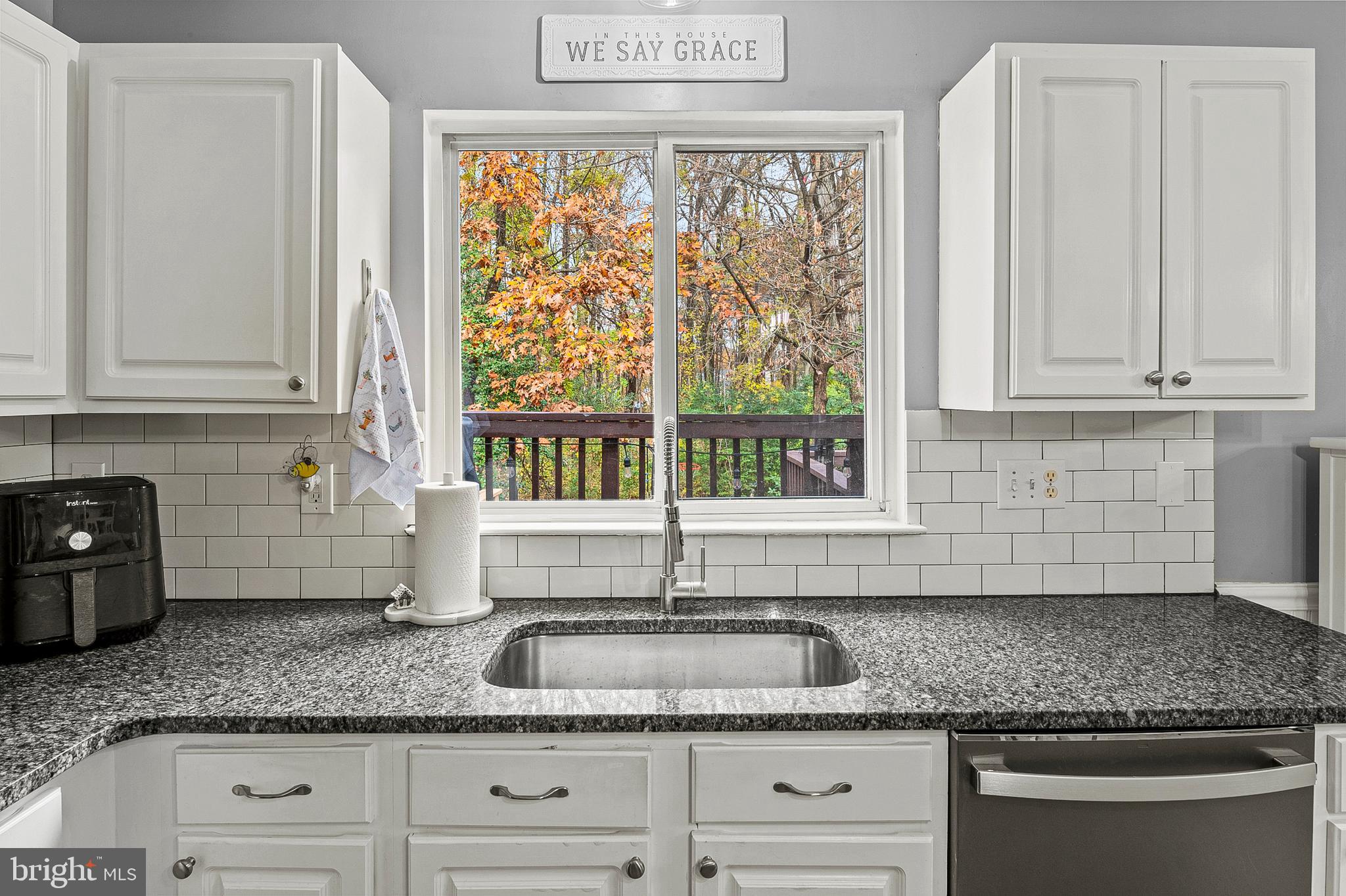 222 Gray Fox Court Edgewater, MD 21037 - Photo 6 of 42 a kitchen with granite countertop a sink and a white wooden cabinets