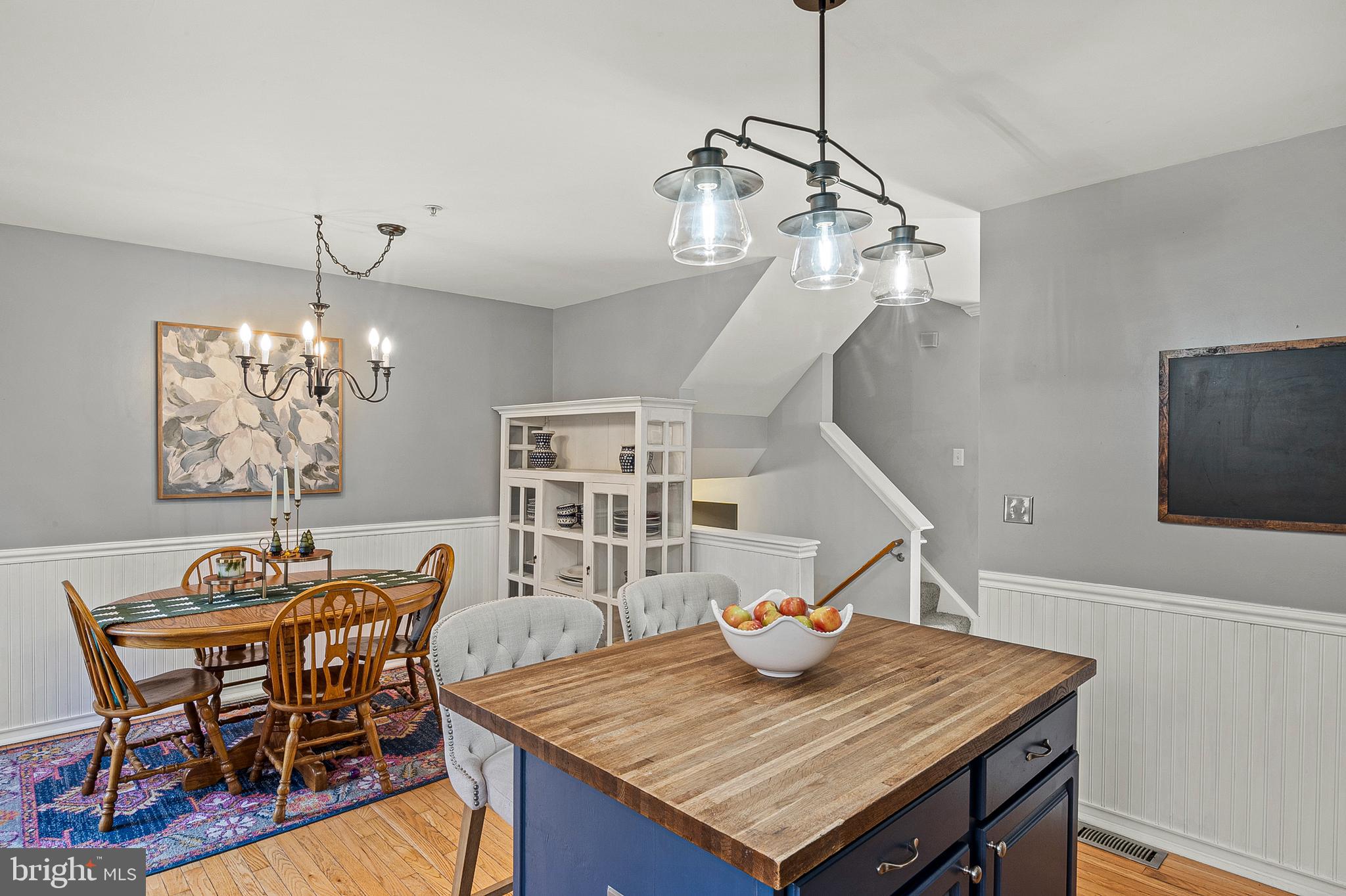 222 Gray Fox Court Edgewater, MD 21037 - Photo 7 of 42 a view of a dining room with furniture a chandelier and wooden floor