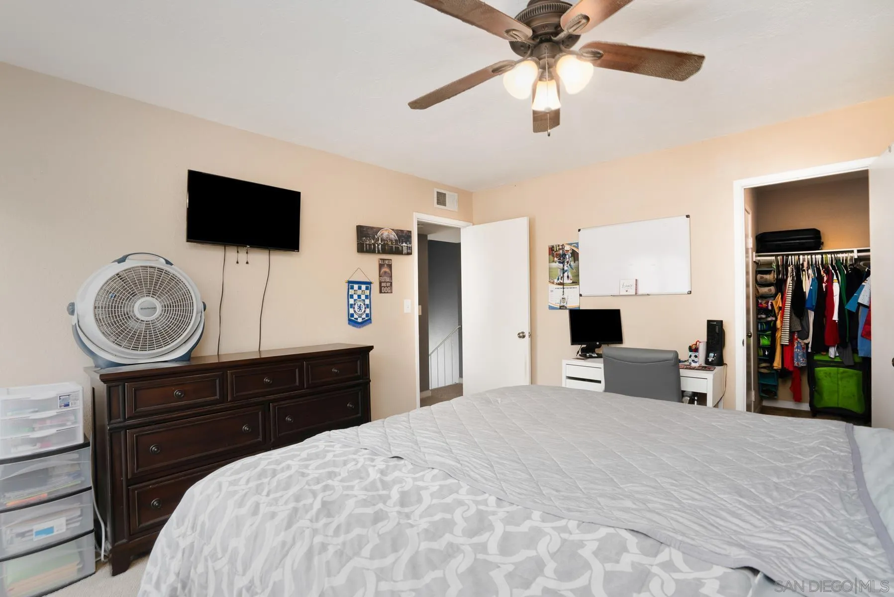 10007 Great Rock Road Santee, CA 92071 - Photo 17 of 26 a bedroom with a bed and a flat tv screen on dresser