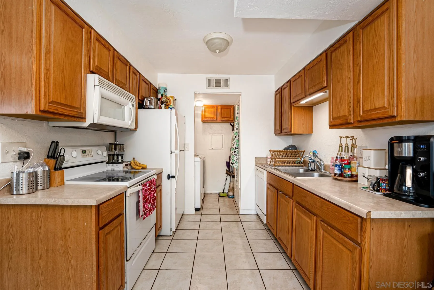 10007 Great Rock Road Santee, CA 92071 - Photo 6 of 26 a kitchen with stainless steel appliances granite countertop a sink stove refrigerator and cabinets