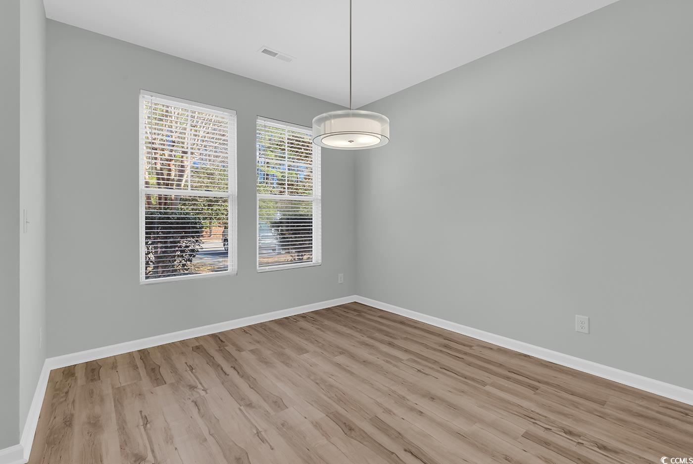 308 Kiskadee Loop, Unit E Conway, SC 29526 - Photo 3 of 36 Spare room featuring baseboards and light wood-style flooring