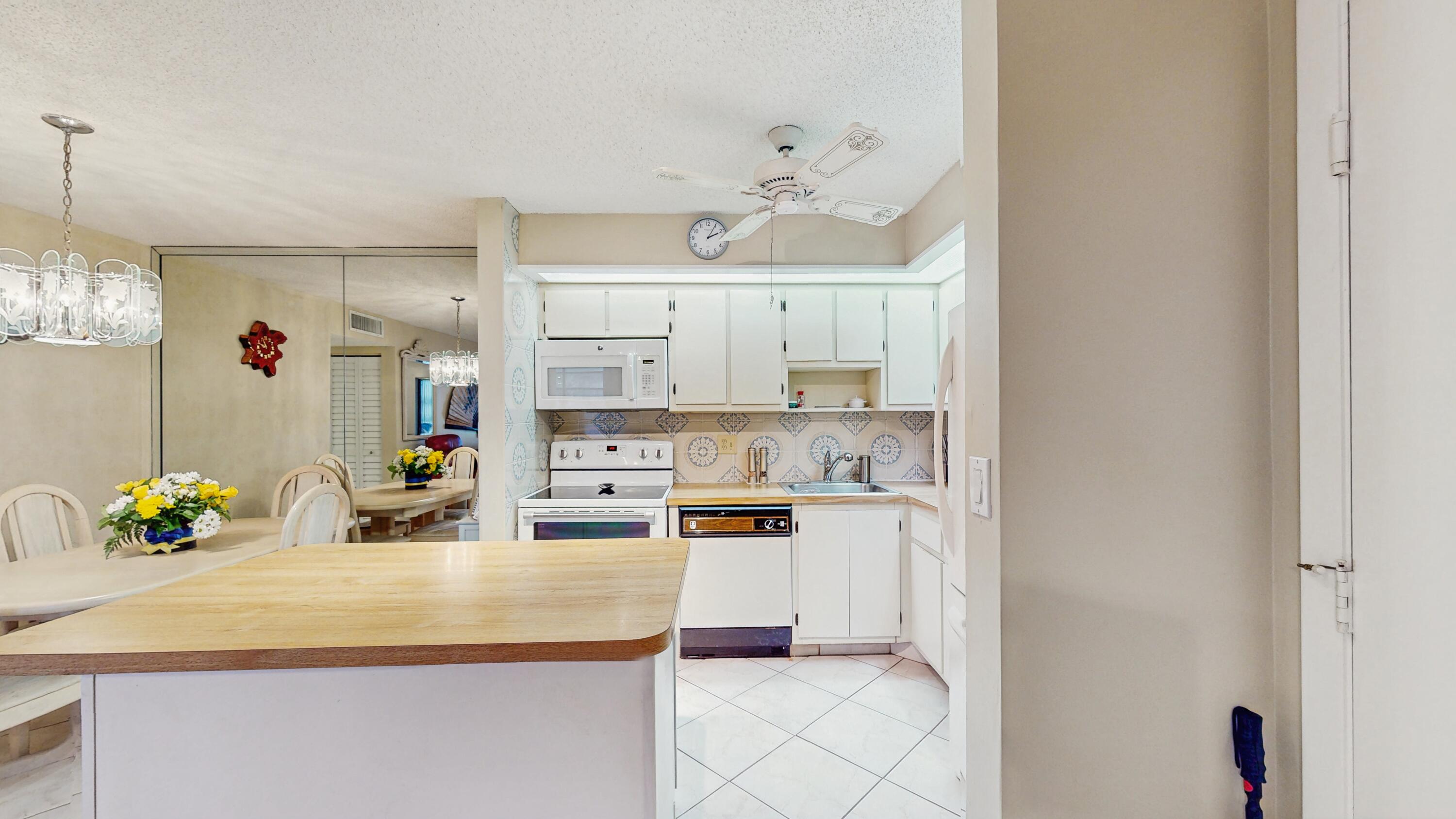 9765 West McNab Road, Unit 115 Tamarac, FL 33321 - Photo 8 of 25 kitchen view with island