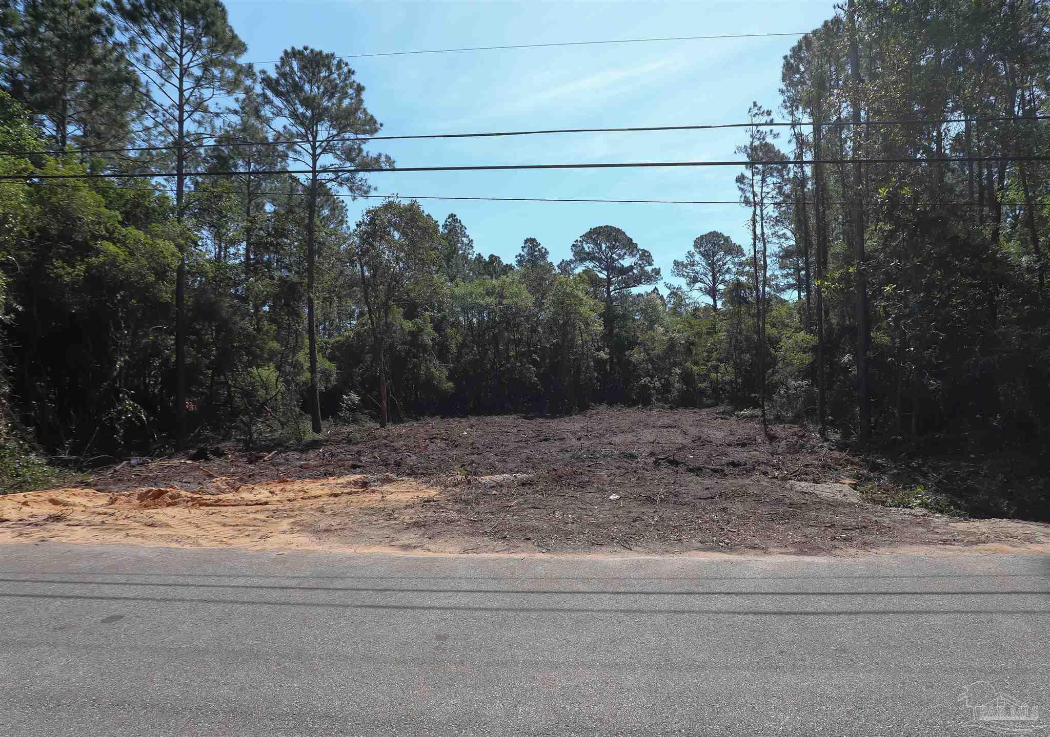 3134 Wells Beach Road Navarre, FL 32566 - Photo 5 of 6 a view of a house with a yard