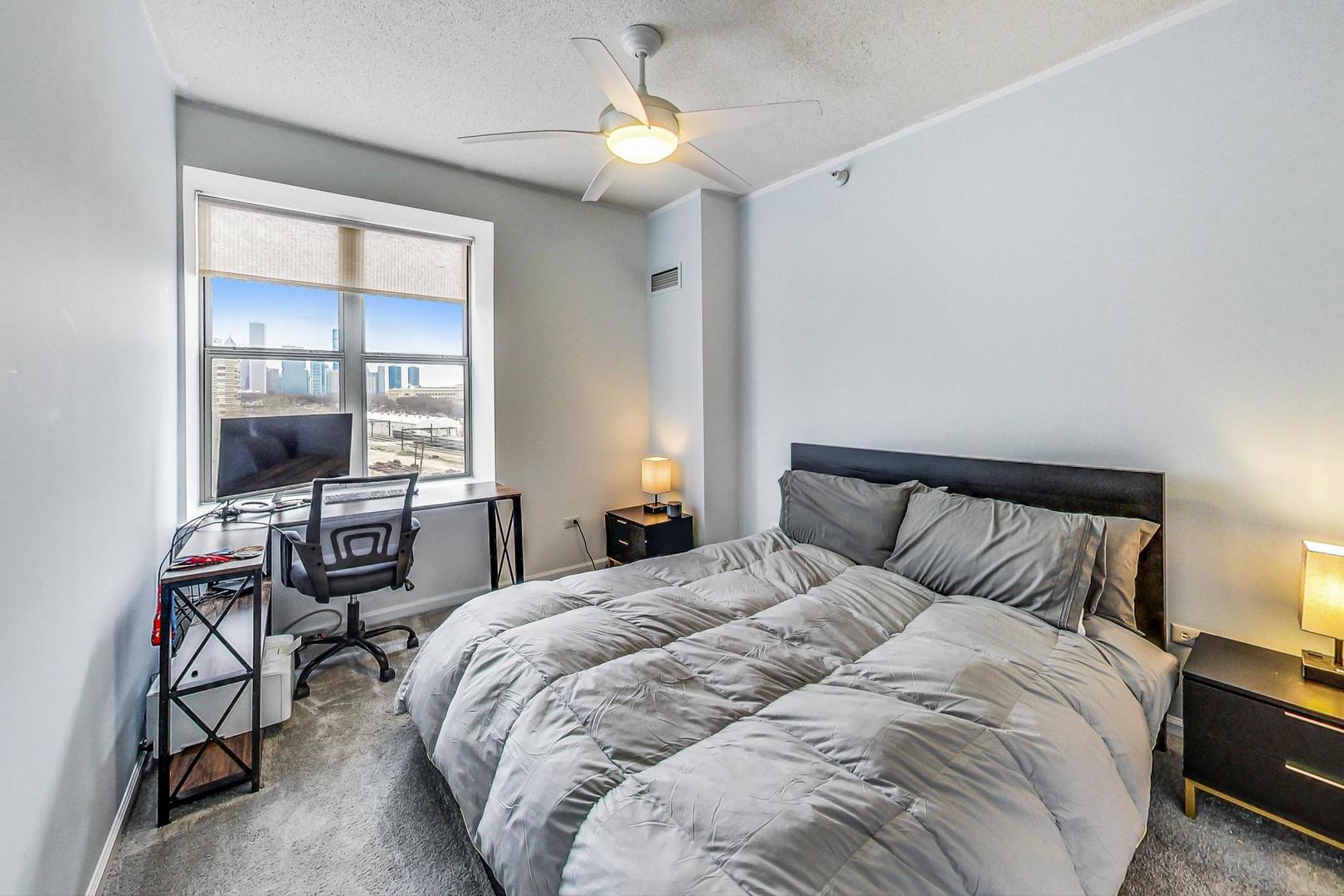 1717 South Prairie Avenue, Unit 802 Chicago, IL 60616 - Photo 11 of 33 a bedroom with a bed and a chandelier