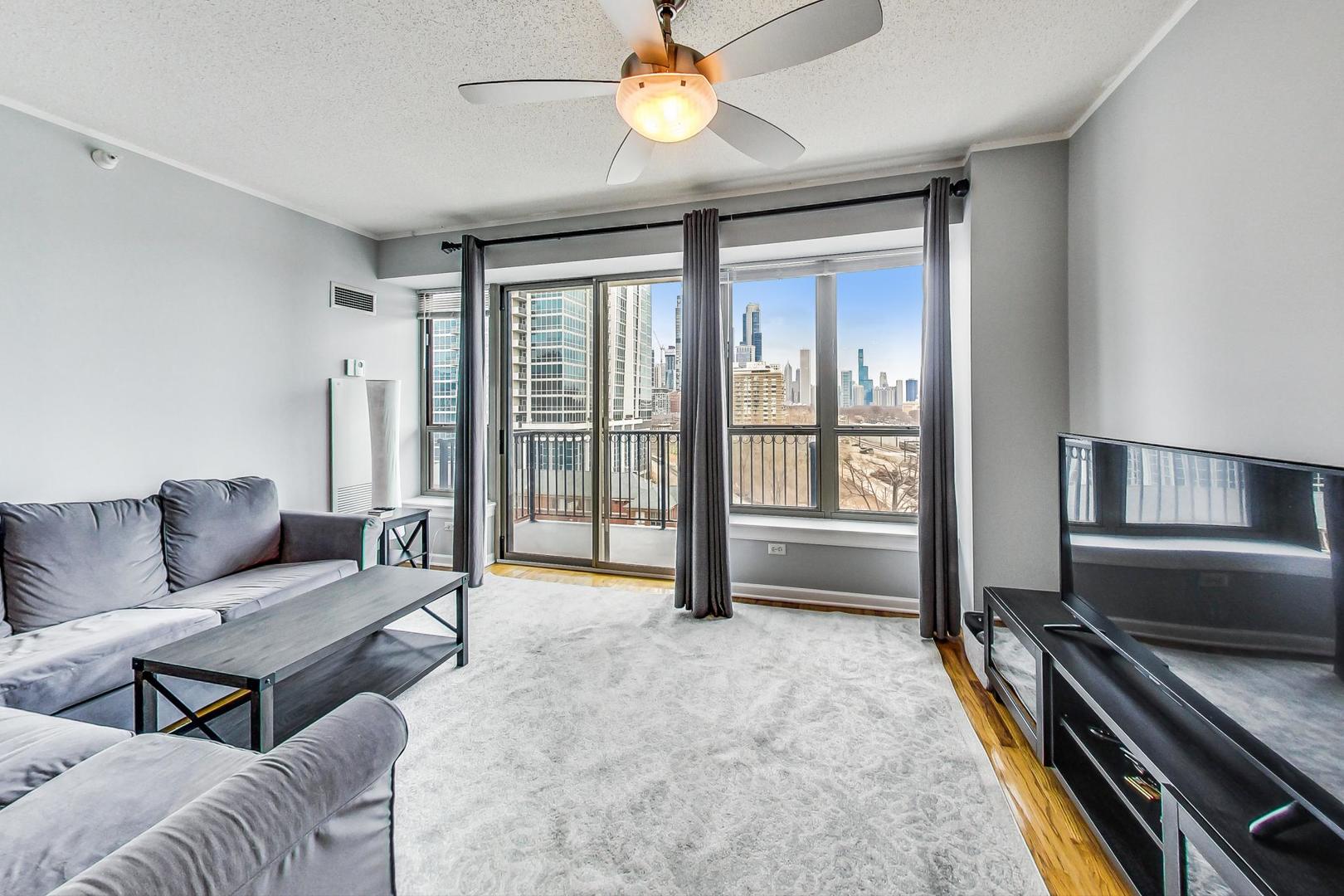 1717 South Prairie Avenue, Unit 802 Chicago, IL 60616 - Photo 2 of 33 a living room with furniture and a ceiling fan