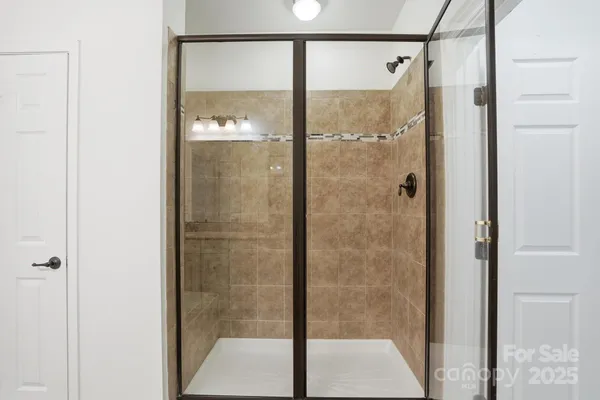 a bathroom with a glass shower door