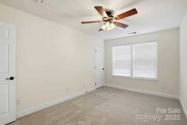 a view of a livingroom with a ceiling fan and window