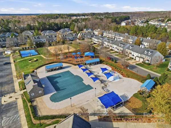 an aerial view of a houses with a swimming pool