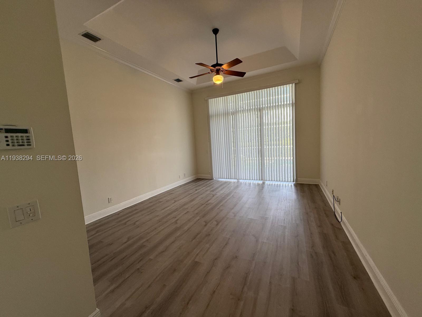 2408 Deer Creek Road Weston, FL 33327 - Photo 13 of 30 wooden floor in an empty room with a window