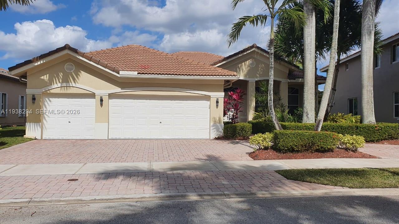 2408 Deer Creek Road Weston, FL 33327 - Photo 2 of 30 front view of a house with a street