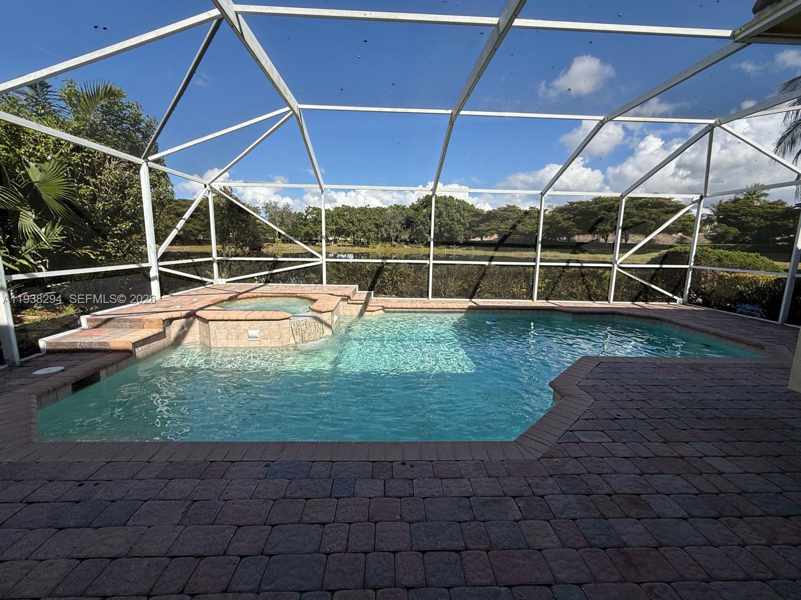 2408 Deer Creek Road Weston, FL 33327 - Photo 23 of 30 a view of a backyard with table and chairs