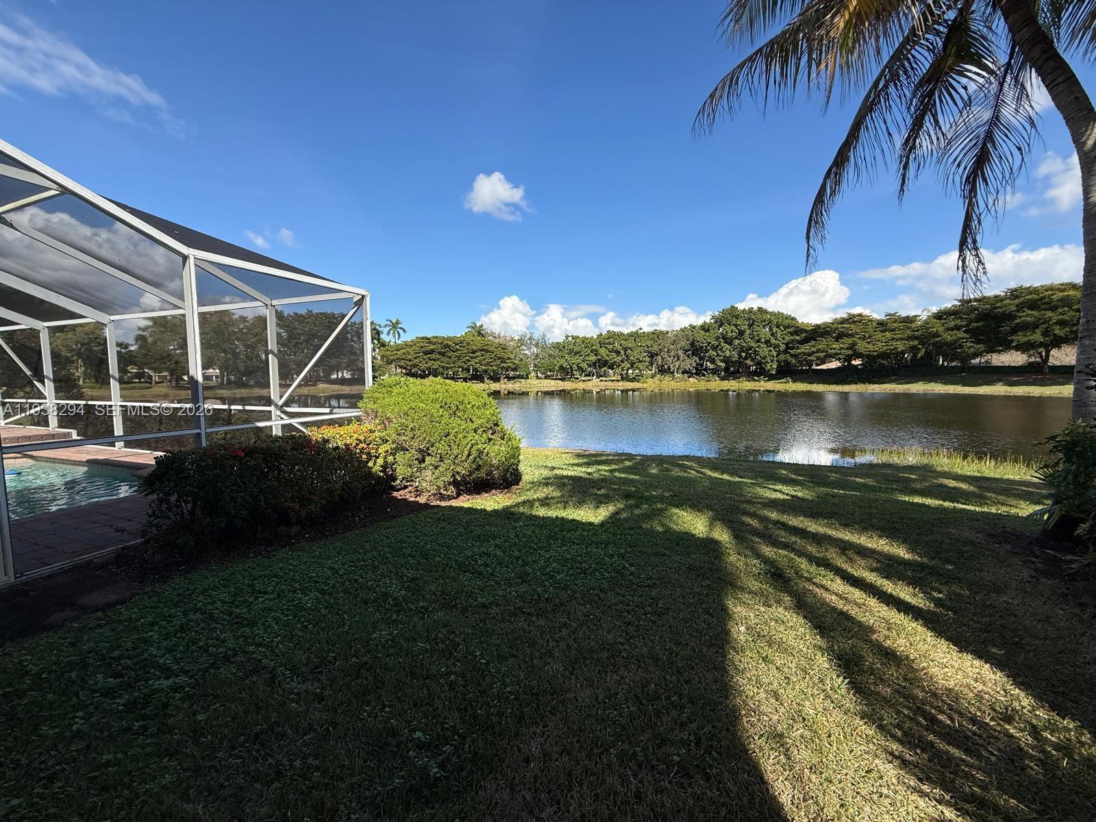 2408 Deer Creek Road Weston, FL 33327 - Photo 25 of 30 a view of a lake with a big yard