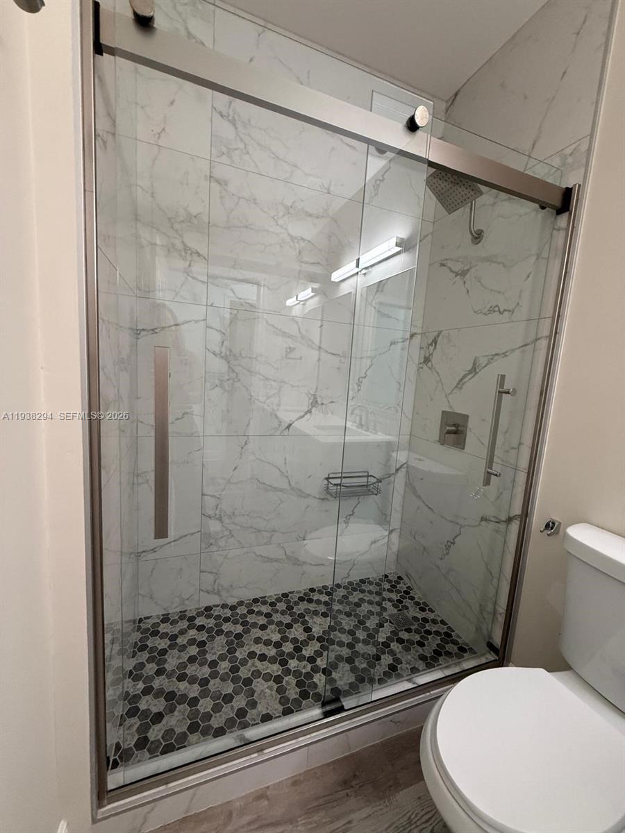 2408 Deer Creek Road Weston, FL 33327 - Photo 27 of 30 a bathroom with a toilet and shower
