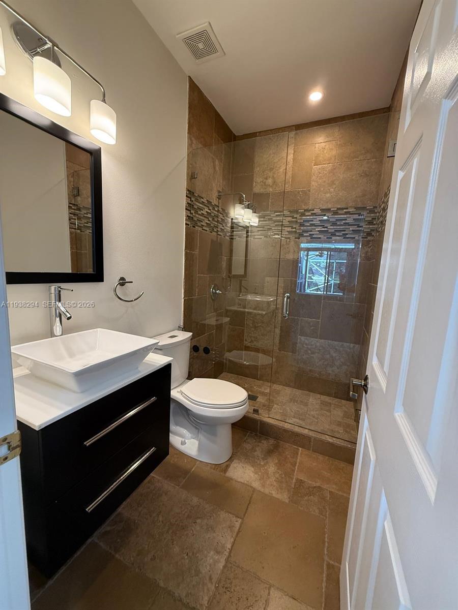2408 Deer Creek Road Weston, FL 33327 - Photo 28 of 30 a bathroom with a sink a toilet and shower