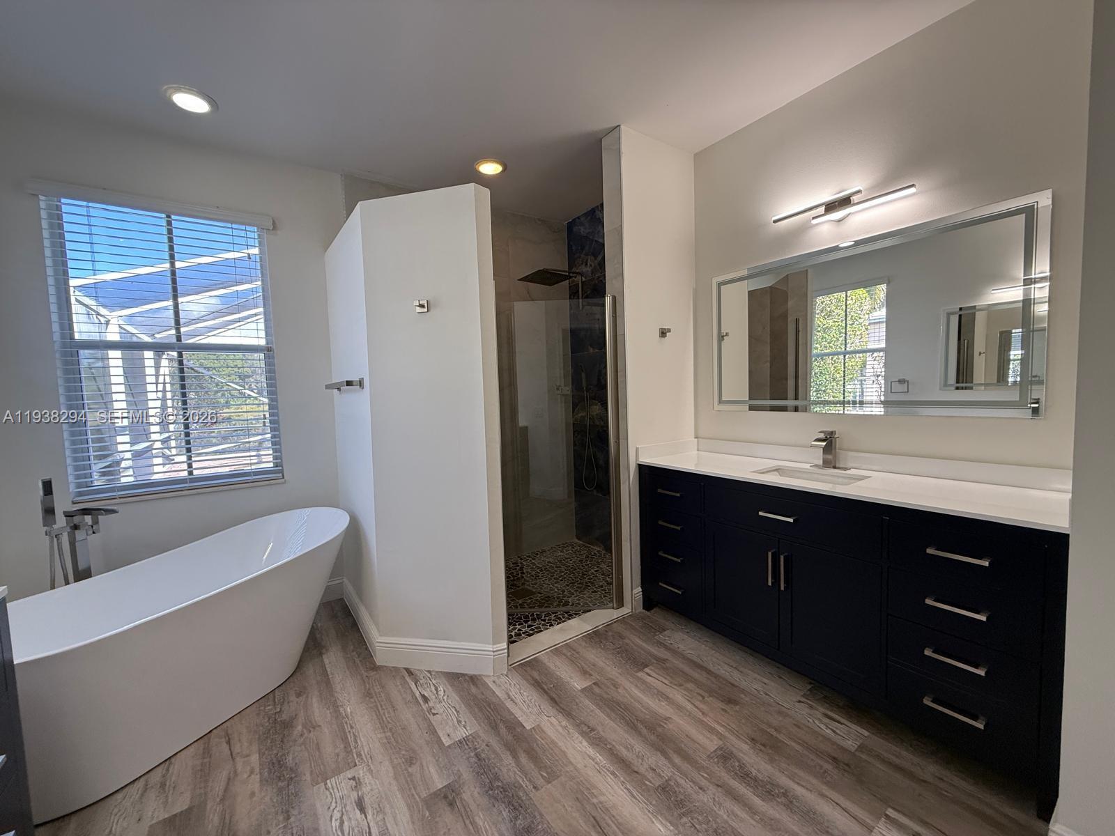 2408 Deer Creek Road Weston, FL 33327 - Photo 30 of 30 a spacious bathroom with a tub sink and mirror