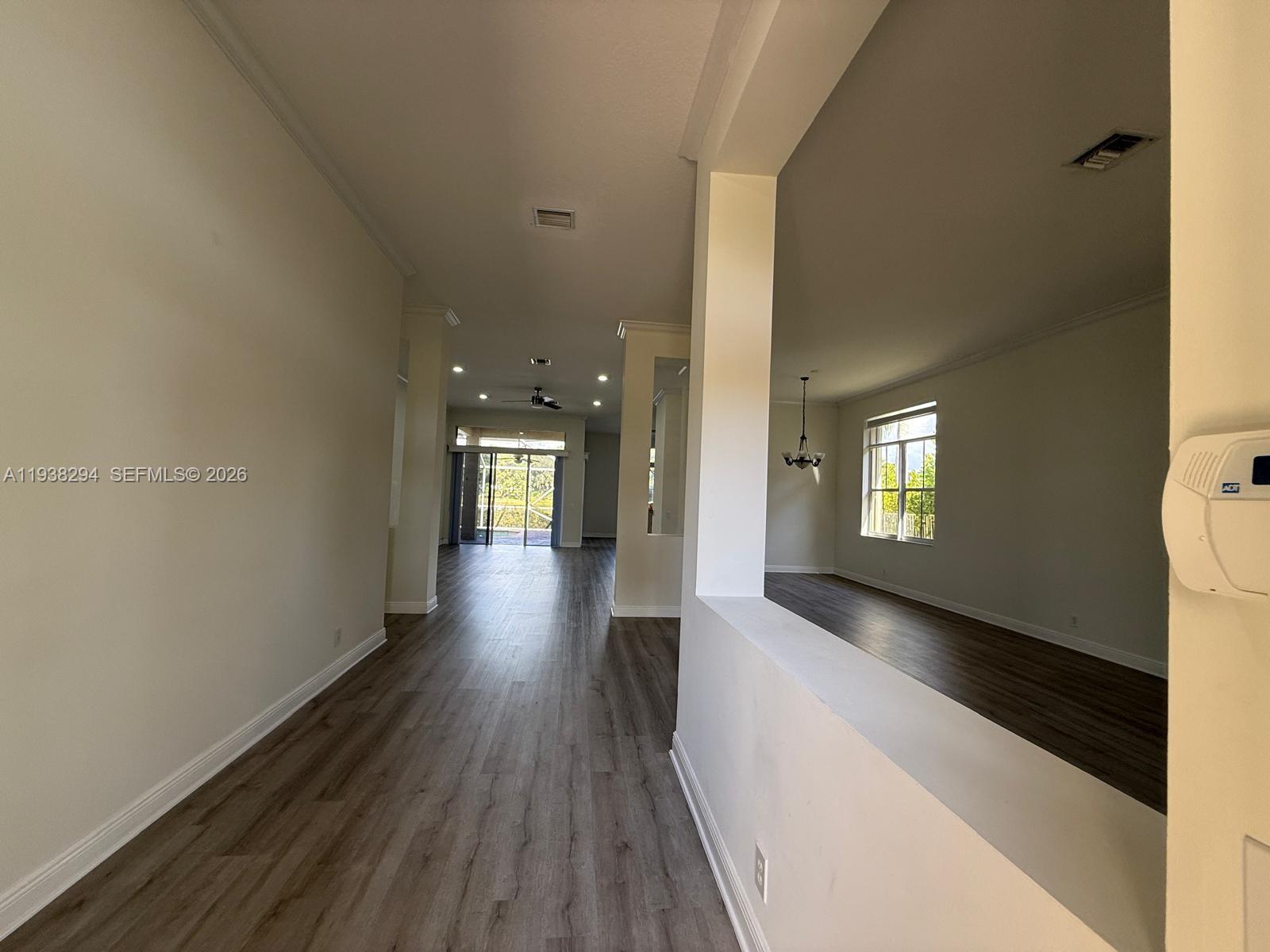 2408 Deer Creek Road Weston, FL 33327 - Photo 4 of 30 a view of a hallway with wooden floor and stairs